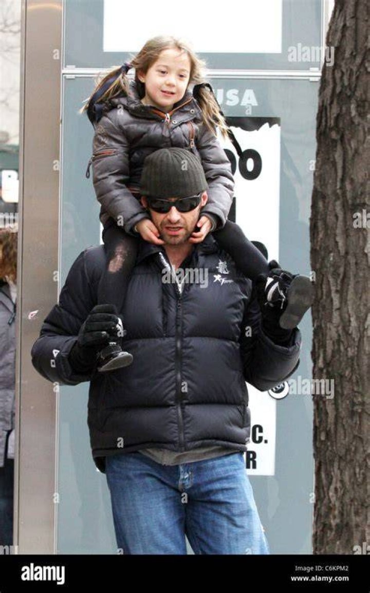 Hugh Jackman carries his daughter Ava Eliot Jackman while walking