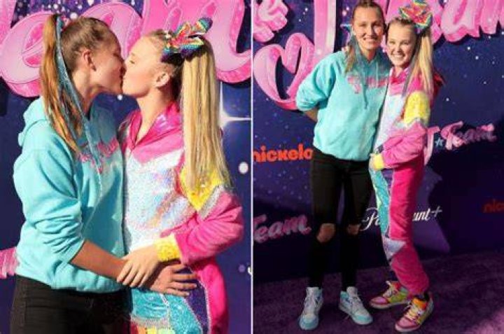 JoJo Siwa kisses girlfriend Kylie Prew as the couple hold hands and